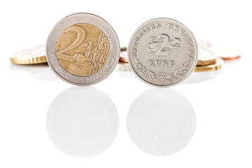 A two-Euro coin next to a two-kuna one © DeymosHR/Shutterstock